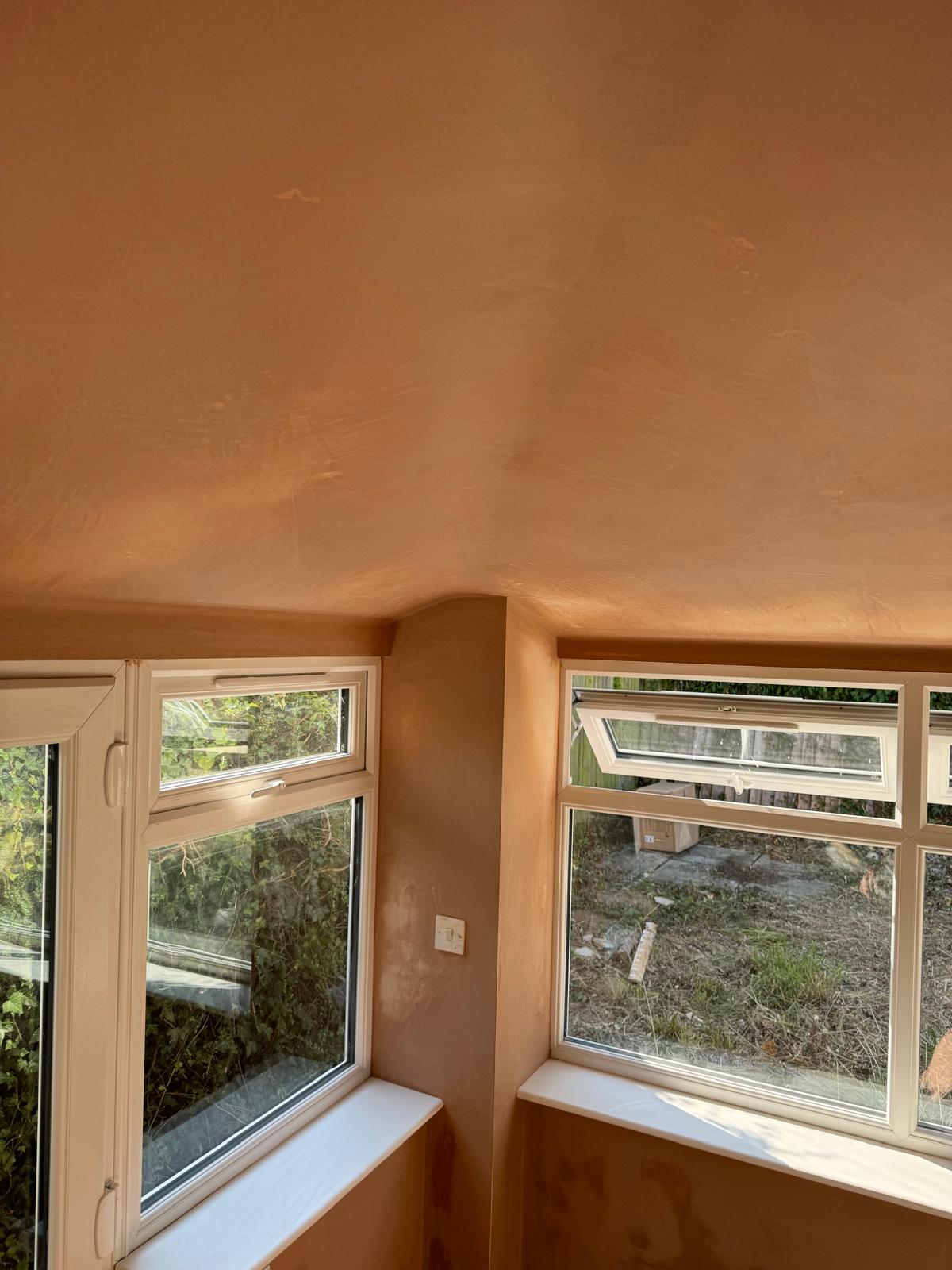 A freshly skimmed ceiling and walls in a corner room